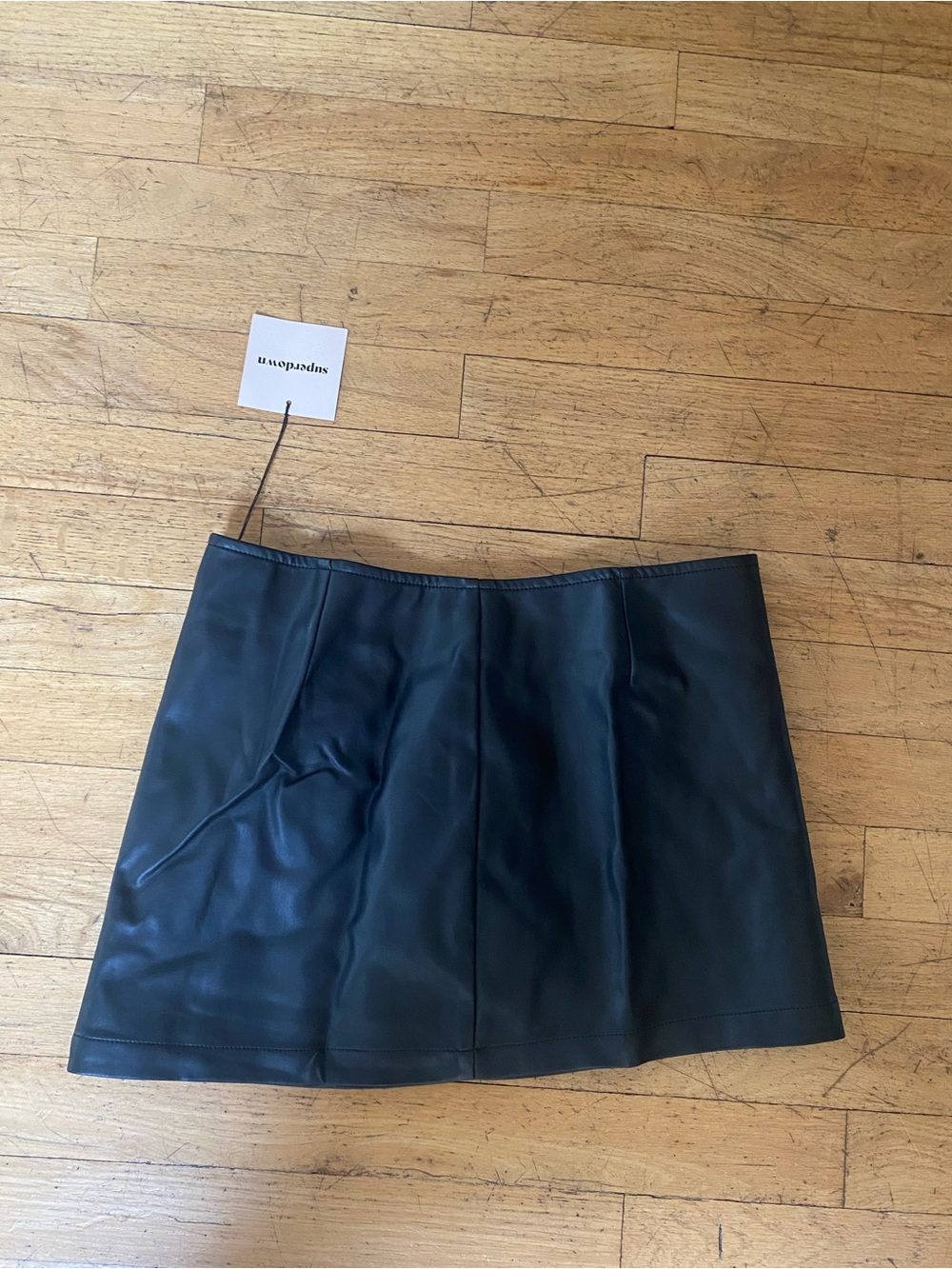 Super down faux leather mini skirt. Back zipper. NWT!! Size xs